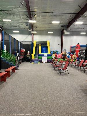 Seating area with trampolines to the left, inflatable slide straight ahead and bouncy house and inflatable maze to the right!