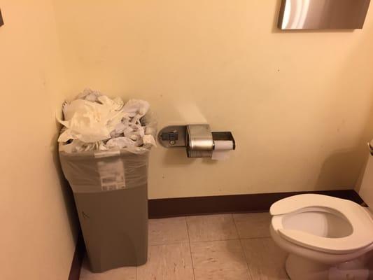 Overflowing trash with bodily fluids on paper towels