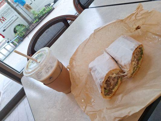 Iced latte and steak and cheese sandwich