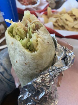 Vegan burrito-veggie burrito no dairy refried beans Mexican rice lettuce guacamole chips and salsa