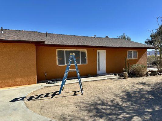 RW Painting - painting the stucco and fascia of our house. Applying elastomeric paint here.