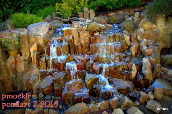 Pondless waterfall using mini basalt columns. Water is recirculated from a 200 gal reservoir by two 3000 gph pumps, timer controlled