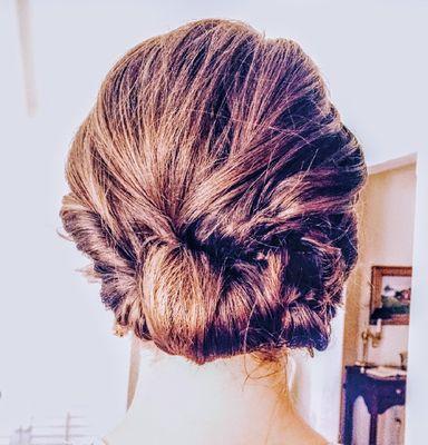 Twists with low swept up bun bridesmaid style.