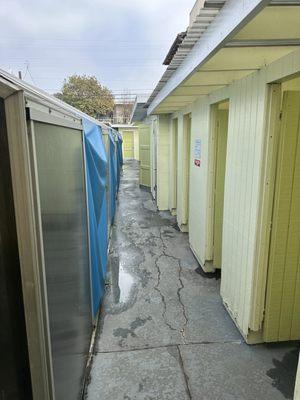 Hall way of rooms. First few are dressing rooms, Middle is shower, and back is restrooms.