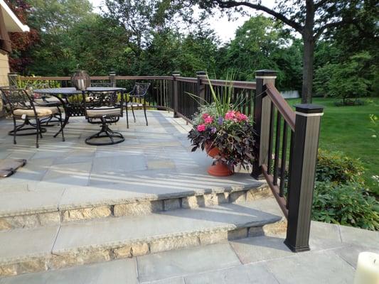 CUSTOM STONE PATIO WITH TIMBERTECH RADIANCE RAIL