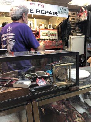 The older man repairing shoes.