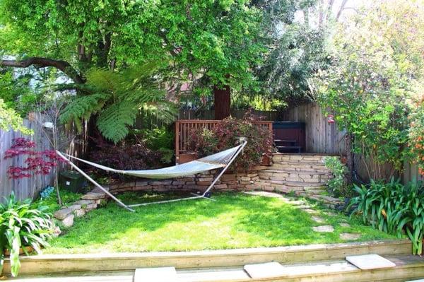 Custom redwood deck (built around the redwood tree) to hold my hot tub with rock stairs to match the landscaping.