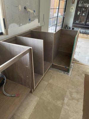 He promises that he has cabinets ready! Where are the doors - drawers - shelving?  Wood is crooked uneven ... etc!