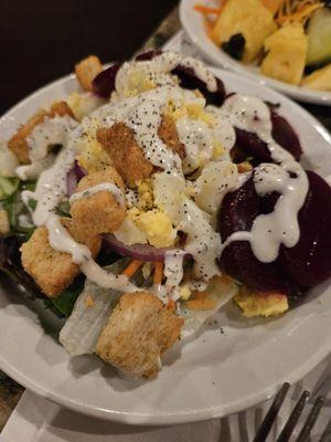 Green salad, eggs, beets, red onion, croutons, and crackers. Ranch dressing, of course...fresh fruit. Actually a nice salad.