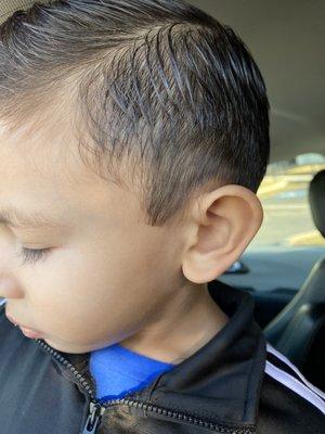 Long pieces of hair around his ear.