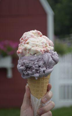 Strawberry Cheesecake on top of Black Raspberry in a waffle cone