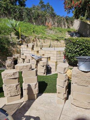 Building a deck on the hillside along with a retaining wall from RCP. Get the  shaped rock for your yard. Believe only $27...