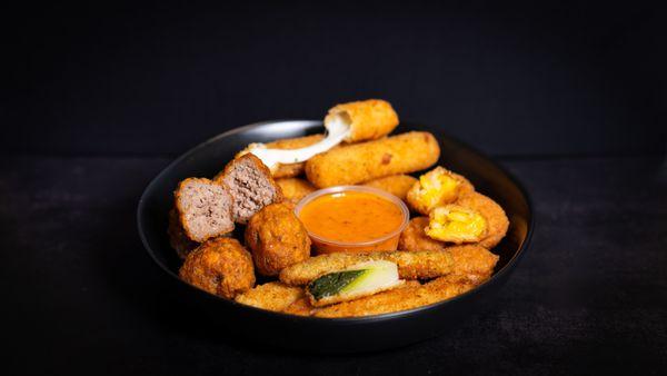 Loaded Bite Sampler: Burger bites, mozz sticks, sweet corn nuggets and zucchini sticks, served with your choice of dipping sauce!