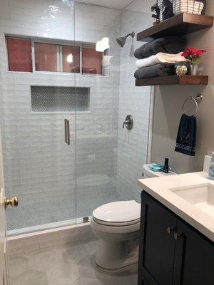 Downstairs bathroom, shower stall and floor tile.