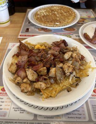 Chicken Chicken Melt Hashbrown Bowl with sautéed onions and bacon