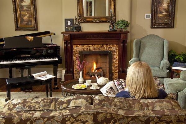 The parlor with fire place and baby grand piano