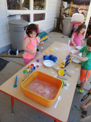 My daughter at outside play ,one of the activity tables