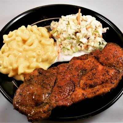 Pork Steak plate with mac n cheese and coleslaw.