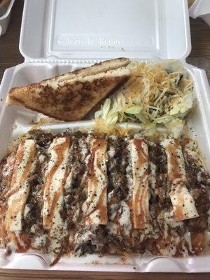 Baked potato with brisket, salad and toast.