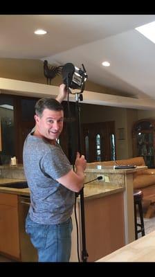 Setting up lights for a client video in their home