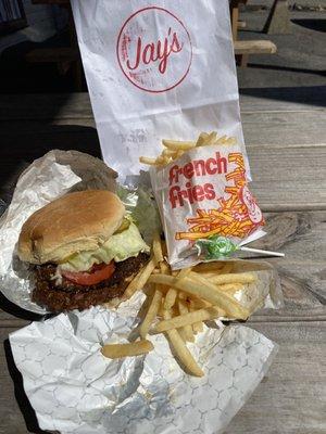 Classic burger with everything, crispy fries, and a lollipop