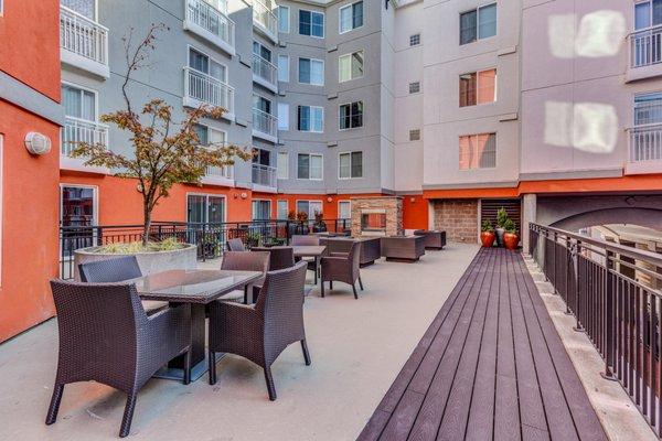 Courtyard with fireplace and lounge seating.