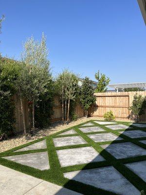 Created concrete and turf in diamond pattern after removing grass, leveling the ground and adding drains.