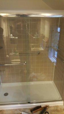 Bathroom remodel with glass frame-less sliding doors.  Matched original tile from 50's! Additional handicap railings incl.