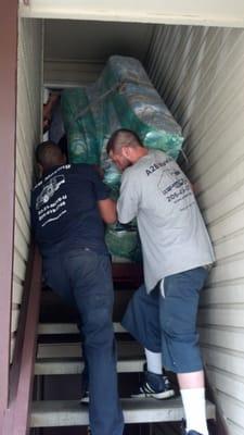 A2B Moving Company carefully maneuvering our piano down the stairs.