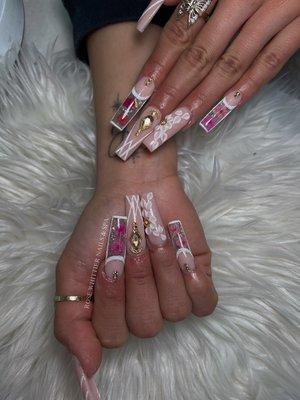 Long Acrylic Nails with Flower Designs and Nail Rhinestones