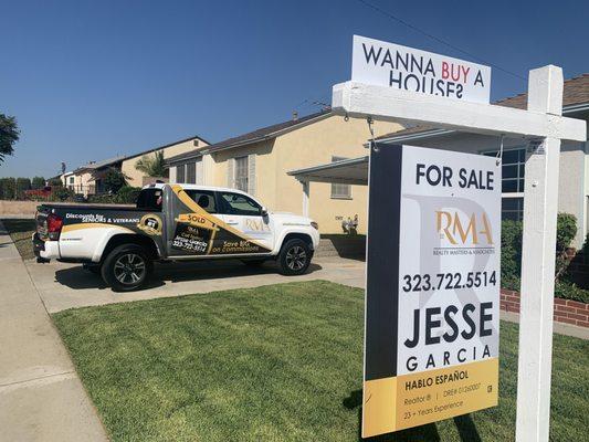 Selling real estate in Los Angeles. The for sale sign with the real estate truck.