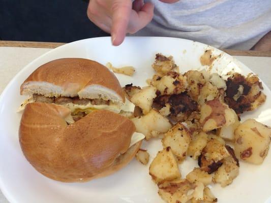 Breakfast bagel sandwich and home fries