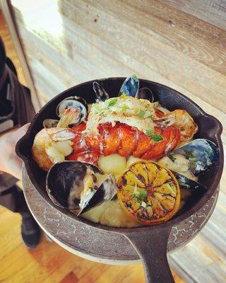 Lobster tail, prawns, clams & mussels in lemon cream over gnocchi