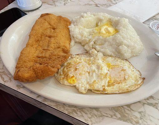 Fried flounder with 2 over easy eggs and grits