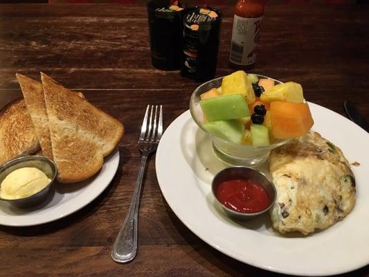 Delicious breakfast: egg white omelet with mushrooms, zucchini, & aged white cheddar, fruit, and sourdough toast. Yum!