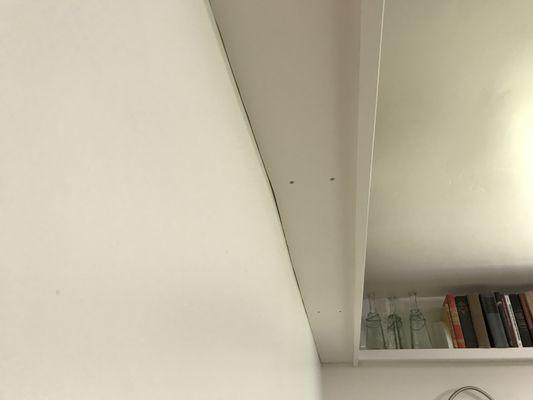 No caulking - gaps between shelves and wall