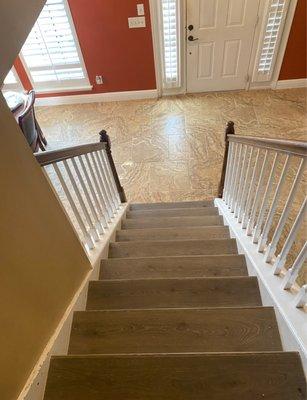 Stairs with Luxury Vinyl and flooring with Porcelain Tiles.