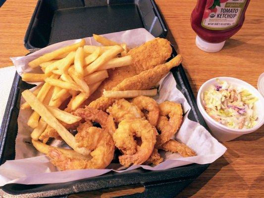 Fried fish and shrimp basket with coleslaw and fries.