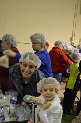 Packing Meals to ship overseas with the organization Kids Against Hunger