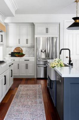 Fresh and bright kitchen Remodel with dark blue accent on the kitchen island