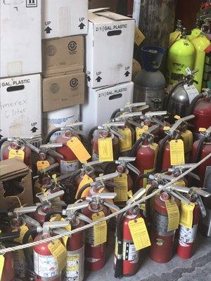 Fire extinguishers and oxygen tanks used by first responders.