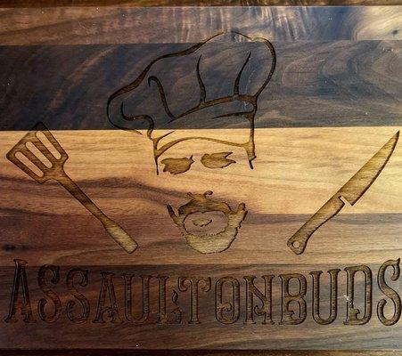 Custom engraved logo on a walnut cutting board.