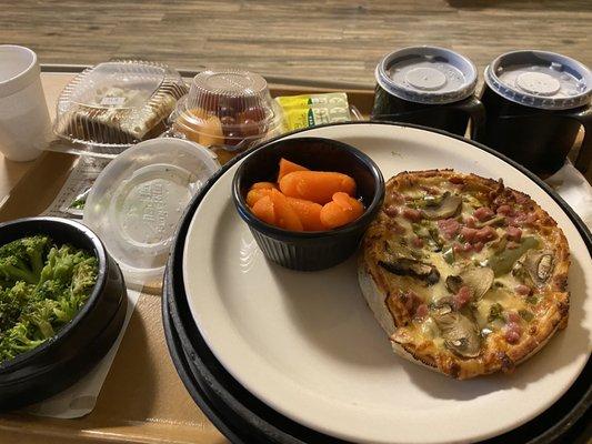 First of pizza was steamed broccoli carrots fruit and even a carrot cake.