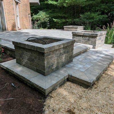 Rochester, Michigan Project showcasing our work of a brick paver patio with wallstone planting boxes