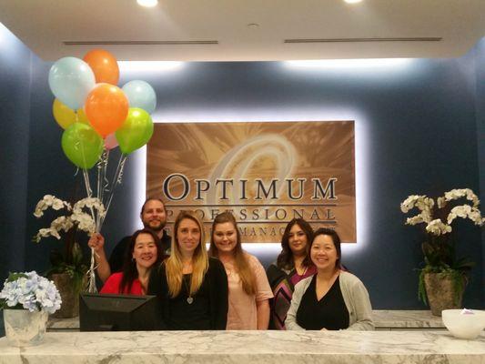 Optimum's Spring Event Team preparing Easter Basket Donation for Olive Crest.