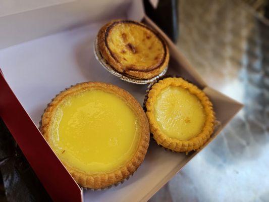 Clockwise deom top right: portugese egg tart, crispy egg tart, and baked egg tart