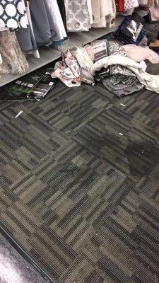 Huge stain and merchandise on the floor.