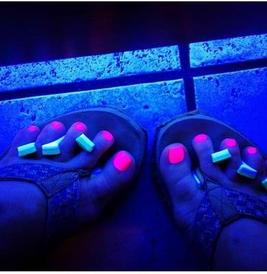 Fluorescent Pink polish under the UV-lamp drying station