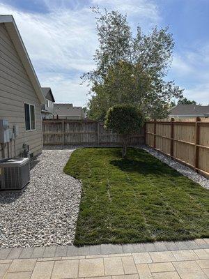 Sod and river rock installation