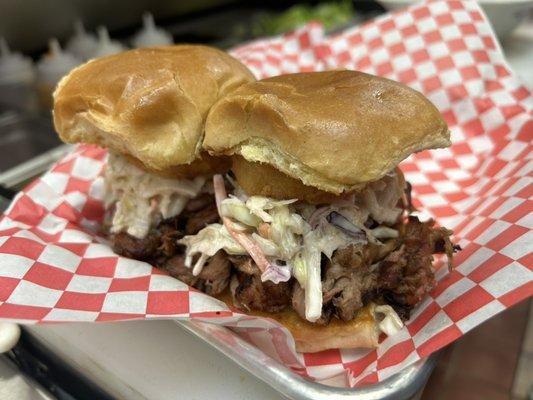 BBQ pulled pork slider topped with coleslaw and an onion ring